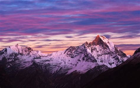 The Top Of The Glacier Machapuchare In The Clouds Nepal Stock Photo