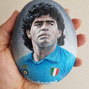 A Hand Holding A Painted Rock With A Man S Face On The Front And Side