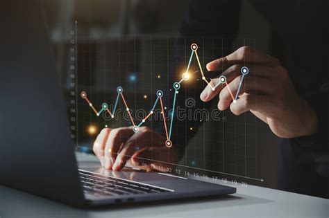 Businessman Using Computer With Graph Growth Analysis On Virtual Screen