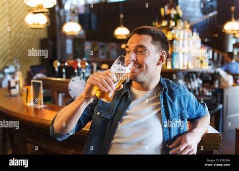 Happy Man Drinking Beer At Bar Or Pub Stock Photo Alamy