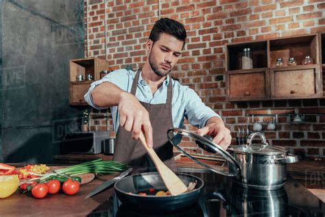 Pensive Handsome Man With Apron Cooking Stock Photo Dissolve