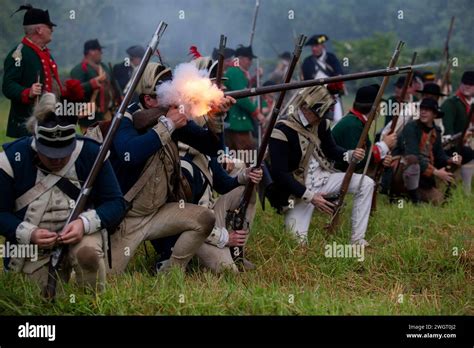 Historical Re Enactors Act Out A Revolutionary War Battle Between The British Red Coats And