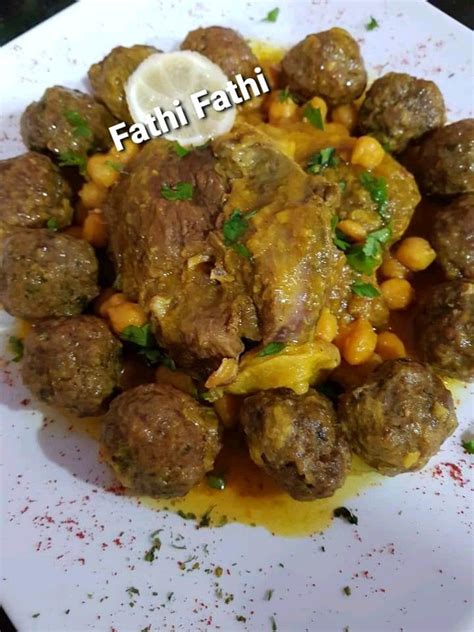 The Meatballs Are Covered In Sauce And Garnished With Parsley