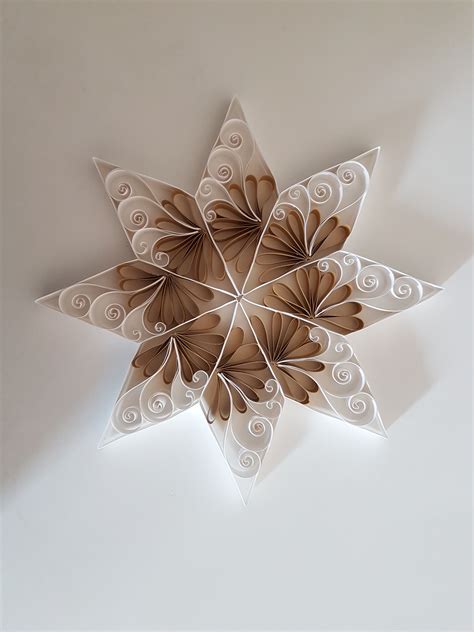 A Paper Snowflake Hanging From The Ceiling