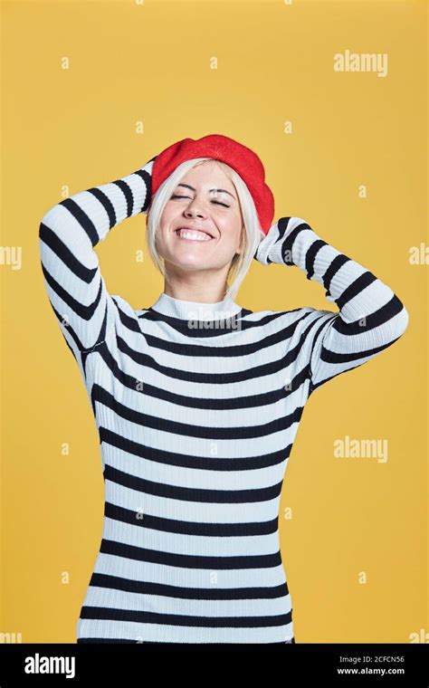 Cheerful Blonde Woman In Striped Blouse And Red French Cap Smiling With