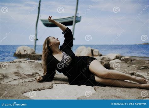 Gorgeous Brunette On The Beach Against The Backdrop Of The Sea A Stock Photo Image Of Body