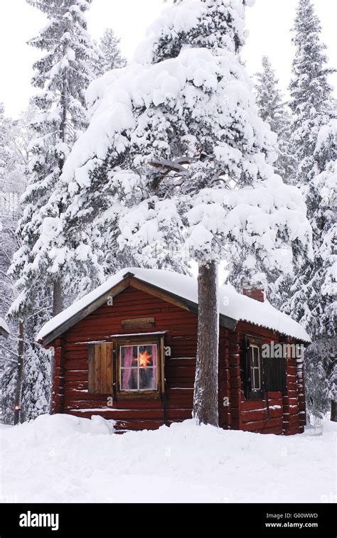 Cabin in snowy forest Stock Photo - Alamy