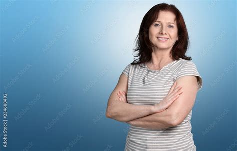 Mature Woman Teacher With Crossed Hands On Background Stock Photo Adobe Stock