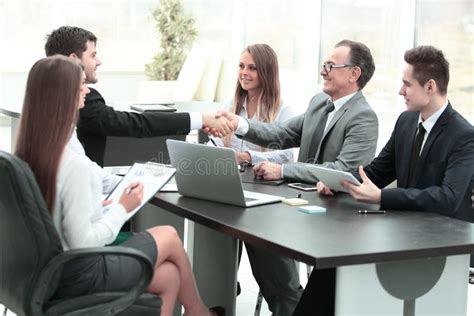 Handshake Of Business Partners At The Negotiating Table Stock Photo