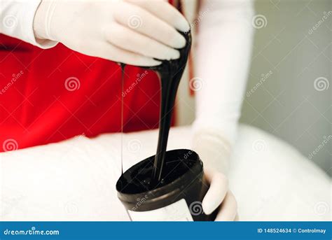 Black Wax For Depilation In The Bank Woman In Gloves Takes A Paste For