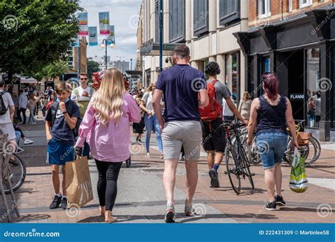 Crowds Of People Shoppers Or Customes Walking Along A Downtown High