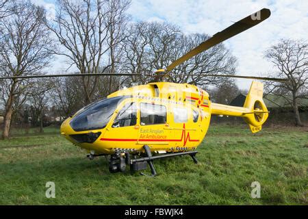 East Anglia Air Ambulance Helicopter Landing On The Beach In Front Of