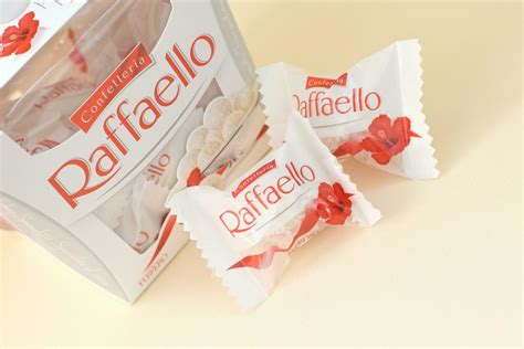 Raffaello candies on beige background. Raffaello is a spherical coconut ...