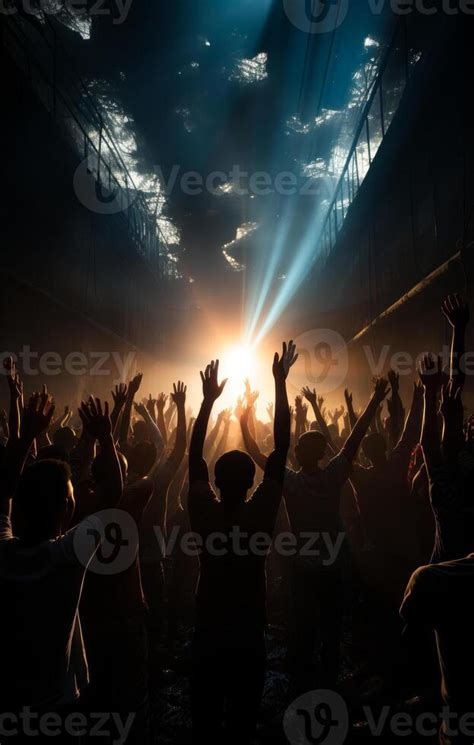 Silhouette of crowd of people dancing at concert with raised up hands ...