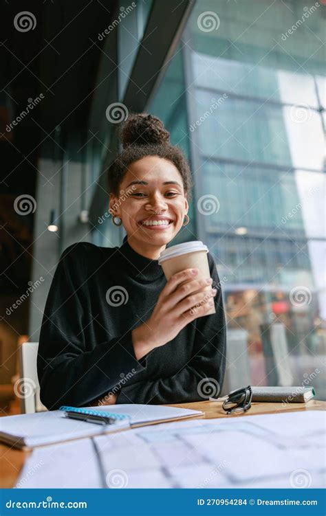 Smiling Female Student Studying On Laptop And Drinking Coffee While