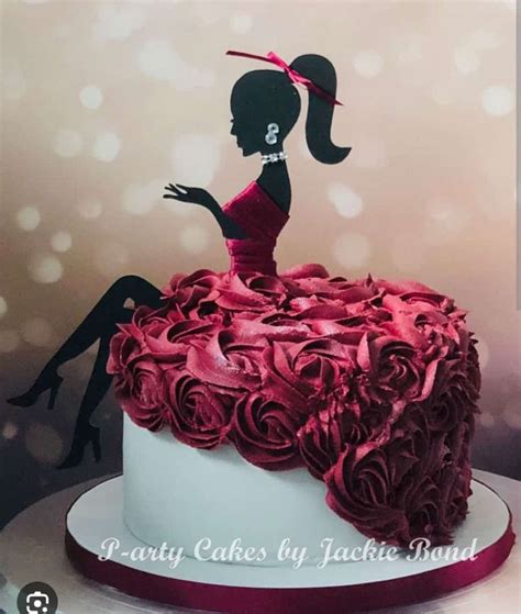 A Cake Decorated With Red Roses And A Silhouette Of A Woman In A Dress