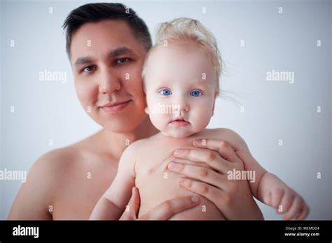 Portrait Of Father Holding Newborn Baby At Home Stock Photo Alamy