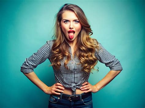 A Young Women Making A Teasing Expression With Her Tongue Out And Hands