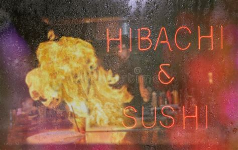 Hibachi Neon Sign With Chef In Background Blur Rainy Window I Stock