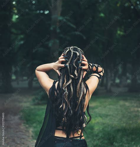 Image of Gorgon Medusa, braid hair and golden snakes, close-up portrait from the back without a ...