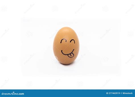 An Egg With A Smiling Face On Top Of It Sitting On The Ground Stock