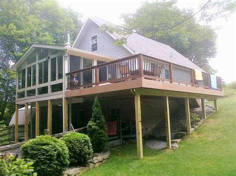 A beautiful sunroom off the back of a house with a deck attached on the ...