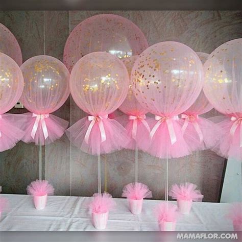 Pink And White Balloons Are On Display In Front Of A Table With Cupcakes