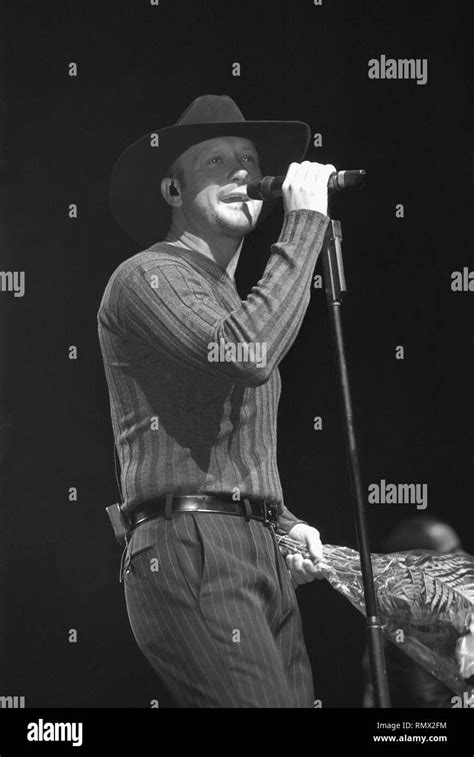 Country Music Singer Tim Mcgraw Is Shown Performing On Stage During A