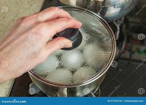 Pot Of Boiling Water In Which White Chicken Eggs Are Boiled Water