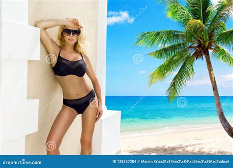 Beautiful Woman In Bikini Posing On The Caribbean Beach Stock Photo