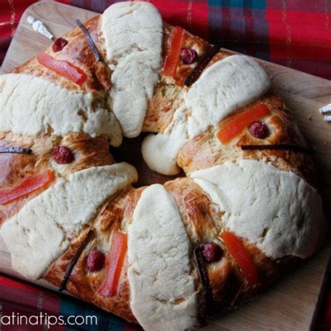 bread with meat and cheese on it sitting on a cutting board