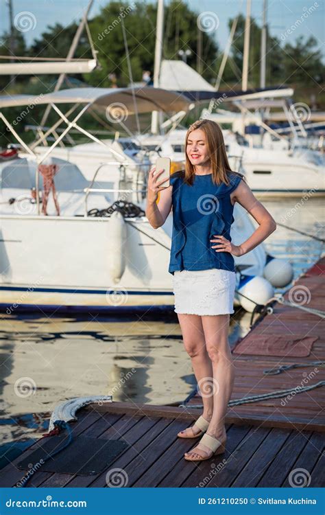 Attractive Woman Taking Selfie Photo On Smartphone While Standing On