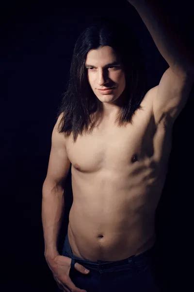 Portrait Of Handsome Man With Long Hair Torso Naked On Black