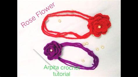 Three Crochet Flowers Are Shown On Top Of A Piece Of Paper With The