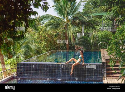 Beautiful Girl In Bikini Relaxing On Poolside At Tropical Resort Stock Photo Alamy