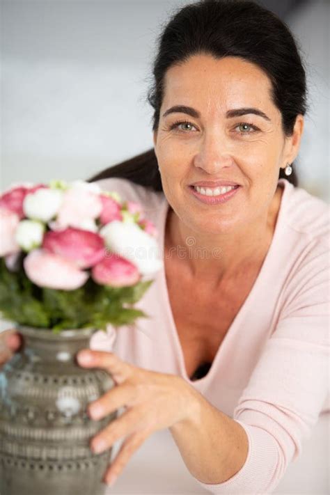 Beautiful Woman Arranging Flowers Picked From Garden Stock Photo