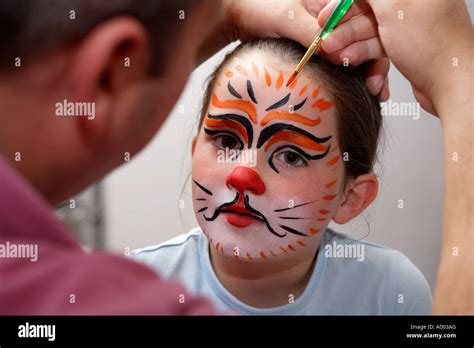 Girl 6 7 8 9 With Her Face Painted In The Design Of A Pussy Cat Or Stock Photo Royalty Free