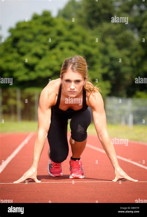 Woman On Running Race Track In Start Position Stock Photo Alamy