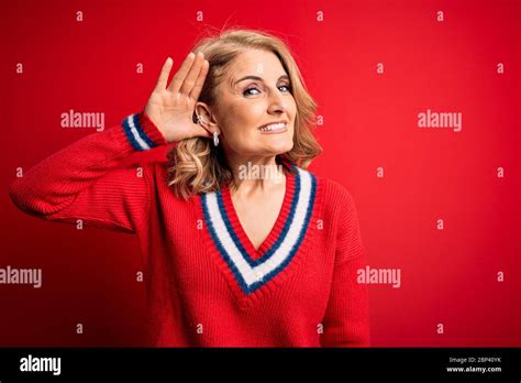 Middle Age Beautiful Blonde Woman Wearing Casual Sweater Over Isolated Red Background Smiling