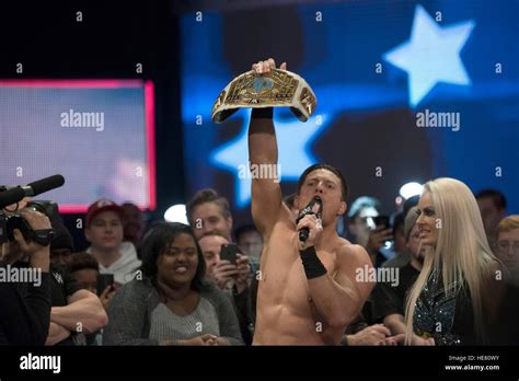 WWE performer The Miz holds up a championship belt after a wrestling ...