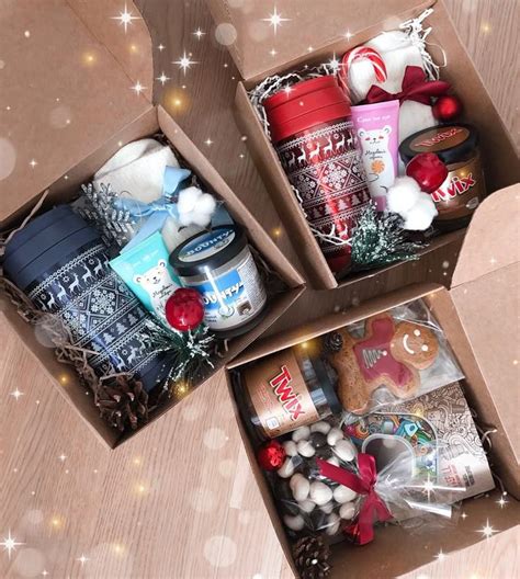 two boxes filled with christmas items on top of a wooden table
