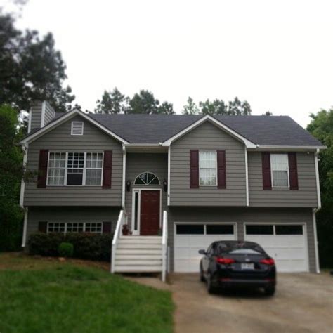 white siding house with brown shutters - Jule Dew