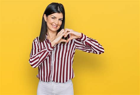 Beautiful Brunette Woman Wearing Striped Shirt Smiling In Love Doing