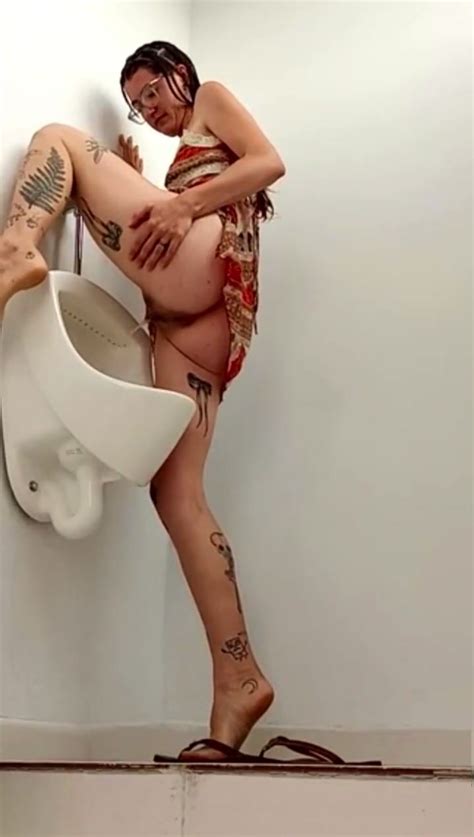 Skinny Tated Babe Pisses Into Urinal ThisVid