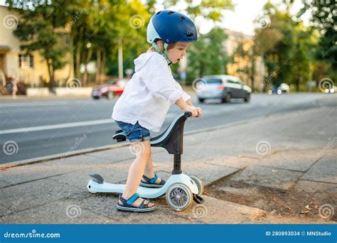 Funny Toddler Boy Riding a Baby Scooter Outdoors on Summer Day. Kid ...