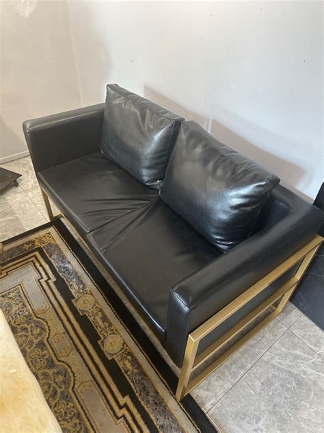 Luxuriate In Style With This Stunning Black And Gold Faux Leather Sofa