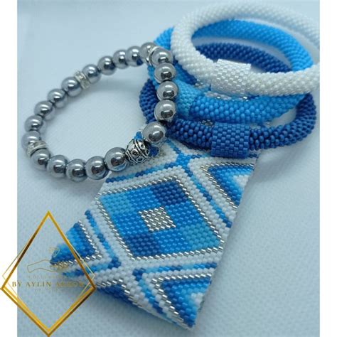 Two Blue And White Beaded Ties With Silver Beads Are On Top Of Each Other