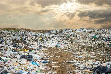 garbage dump pile in trash dump or landfill,backhoe and truck is dumping the gabage from