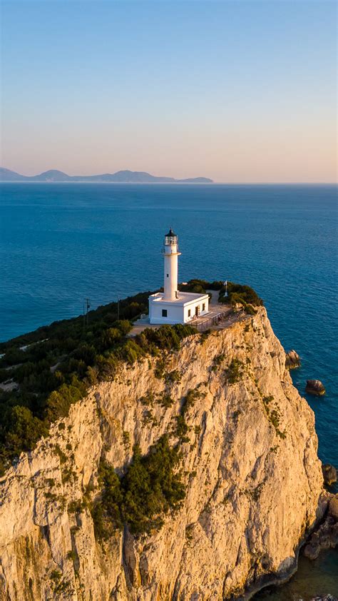 Aerial View Of A Lighthouse Surrounded By Steep Cliffs At Cape Ducato