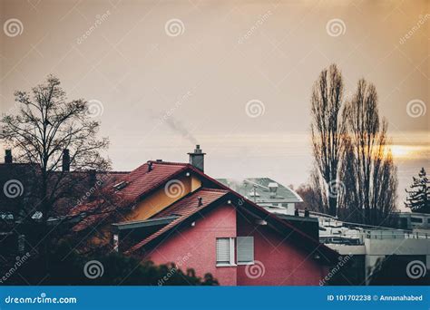 Building Roofs Naked Trees Sunset Fog Over The Lake Stock Photo